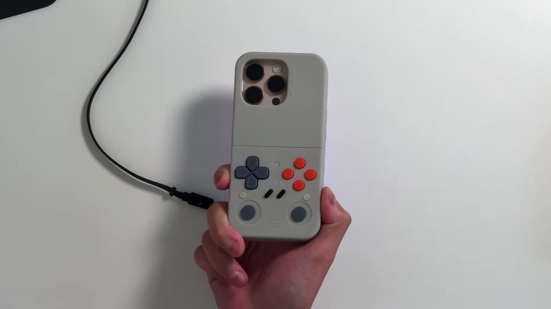 Gray SOOLRA case for iPhone 16 Pro with the controller section in carry position
